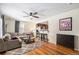 Inviting living room with hardwood floors, neutral-toned furniture, leading to the kitchen at 11 S Perry St, Denver, CO 80219