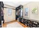 Bright walk-in closet with custom shelving, shoe rack and hardwood floors at 11 S Perry St, Denver, CO 80219