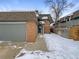 Brick townhouse exterior with attached garage and snow-covered walkway at 3850 Paseo Del Prado # 7, Boulder, CO 80301