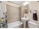 Tiled bathroom features a shower-tub, vanity and light fixtures at 2252 Lamar St, Edgewater, CO 80214