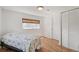 Bedroom featuring wood floors, a large window, and a comfortable bed at 2252 Lamar St, Edgewater, CO 80214