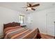 Bedroom featuring wood floors, a ceiling fan, and a quilt-covered bed at 2252 Lamar St, Edgewater, CO 80214