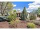 Landscaped front yard with lush greenery and mature trees enhances curb appeal at 2252 Lamar St, Edgewater, CO 80214