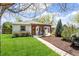 Charming home with a pergola-covered porch and well-maintained front yard at 2252 Lamar St, Edgewater, CO 80214