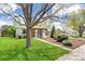 Charming single-story home with green lawn, mature trees, and a welcoming front porch at 2252 Lamar St, Edgewater, CO 80214