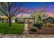 Twilight view of a charming single-story home featuring a manicured lawn and inviting front porch at 2252 Lamar St, Edgewater, CO 80214