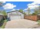 Spacious garage with a basketball hoop and a large driveway at 2252 Lamar St, Edgewater, CO 80214