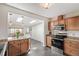 Bright kitchen with wood cabinets, updated appliances, and a view into the dining area with skylights at 2252 Lamar St, Edgewater, CO 80214