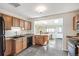 Functional kitchen with wood cabinets, tile flooring, and open access to the dining area at 2252 Lamar St, Edgewater, CO 80214