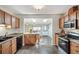 Well-lit kitchen featuring tile floors, wood cabinets, and an adjacent dining area with lots of light at 2252 Lamar St, Edgewater, CO 80214