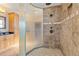 A luxurious bathroom featuring a large walk-in shower with beautiful tile and a rain shower head at 7398 Weaver Cir, Castle Rock, CO 80104
