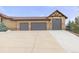 Exterior view of a home showcasing a three-car garage and a wide concrete driveway at 7398 Weaver Cir, Castle Rock, CO 80104