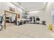 Spacious garage with epoxy flooring, ample storage, and access to workshop and organization for the active homeowner at 7398 Weaver Cir, Castle Rock, CO 80104