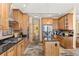 Modern kitchen featuring stainless steel appliances, an island and natural wood cabinets at 7398 Weaver Cir, Castle Rock, CO 80104