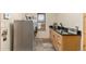 This laundry room features a front load washer and dryer and wood cabinets with a sink and a granite countertop at 7398 Weaver Cir, Castle Rock, CO 80104