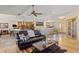 Spacious living room featuring hardwood floors, a ceiling fan, and access to the kitchen at 7398 Weaver Cir, Castle Rock, CO 80104