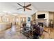 Inviting living room with a stone fireplace, wood beam mantle and hardwood floors at 7398 Weaver Cir, Castle Rock, CO 80104
