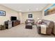 Cozy living room with comfortable leather sofas, a television, and a mini refrigerator at 7398 Weaver Cir, Castle Rock, CO 80104