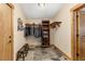 This mud room has tile floors, two benches and wooden accents and a hanging rack for coats and jackets at 7398 Weaver Cir, Castle Rock, CO 80104
