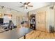 Office featuring hardwood floors and ceiling fan along with view into living room through french doors at 7398 Weaver Cir, Castle Rock, CO 80104