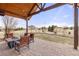 Covered patio with a cozy fire pit and ample seating, perfect for enjoying the serene outdoor space with expansive views at 7398 Weaver Cir, Castle Rock, CO 80104