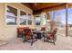 Covered patio features a modern fireplace, comfortable seating, and a paved stone area, perfect for outdoor entertaining at 7398 Weaver Cir, Castle Rock, CO 80104