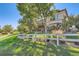 Lovely backyard showcasing a fence, mature trees and a view of the home's beautiful architecture at 4285 Corte Bella Dr, Broomfield, CO 80023