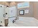 Bright bathroom featuring a glass-enclosed shower, soaking tub, and white tile surround, plus window shutters at 4285 Corte Bella Dr, Broomfield, CO 80023