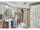 Bathroom features a glass shower and a pedestal sink with decorative tile work at 4285 Corte Bella Dr, Broomfield, CO 80023