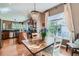 Open-concept dining area adjacent to the kitchen featuring a wood table and chairs plus modern light fixture at 4285 Corte Bella Dr, Broomfield, CO 80023