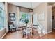 Charming dining area with a wooden table, elegant chandelier, and large window with natural light at 4285 Corte Bella Dr, Broomfield, CO 80023