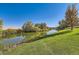 Scenic pond view with mature trees reflecting on the water, enhancing the property's charm at 4285 Corte Bella Dr, Broomfield, CO 80023