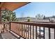 Balcony with wood railing overlooking parking and trees at 540 S Forest St # 3-204, Denver, CO 80246