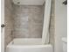 Bathroom features a shower over the tub with gray tiling and a shower curtain at 540 S Forest St # 3-204, Denver, CO 80246