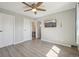 Spacious bedroom with hardwood floors, a ceiling fan, and two doors at 540 S Forest St # 3-204, Denver, CO 80246