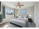 Staged bedroom with hardwood floors, a ceiling fan, a large window, and stylish furnishings at 540 S Forest St # 3-204, Denver, CO 80246