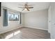 Bright bedroom with hardwood floors, a ceiling fan, and a large window at 540 S Forest St # 3-204, Denver, CO 80246