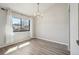 Bright dining room with ample natural light provided by a large window and stylish chandelier at 540 S Forest St # 3-204, Denver, CO 80246