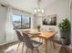 Light-filled dining room features a table set for four, a window view, and decorative accents at 540 S Forest St # 3-204, Denver, CO 80246