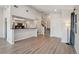 Welcoming entryway with open-concept design, light wood floors, and staircase leading to the upper level at 540 S Forest St # 3-204, Denver, CO 80246