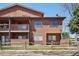 Exterior elevation showcasing the home's two stories, windows, balcony, and wood facade at 540 S Forest St # 3-204, Denver, CO 80246