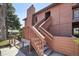 Exterior view of the building featuring a private entrance with stairs, wood facade, and chimney at 540 S Forest St # 3-204, Denver, CO 80246