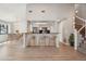 Bright, eat-in kitchen with breakfast bar featuring three chairs, light wood floors, and stainless steel appliances at 540 S Forest St # 3-204, Denver, CO 80246