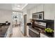 Well-lit kitchen with modern appliances, white cabinets, black countertops, and a dining nook at 540 S Forest St # 3-204, Denver, CO 80246