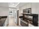 Modern kitchen with stainless steel appliances, white cabinetry, and a skylight for natural illumination at 540 S Forest St # 3-204, Denver, CO 80246