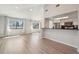 Open living room with hardwood floors, a large window and an open design to the kitchen at 540 S Forest St # 3-204, Denver, CO 80246