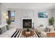 Staged living room with fireplace, neutral walls, wood-look floors, and stylish furnishings at 540 S Forest St # 3-204, Denver, CO 80246
