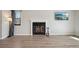 Bright living room showcasing a fireplace with white mantle, a large window, and modern flooring at 540 S Forest St # 3-204, Denver, CO 80246