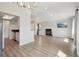 Spacious, open-concept living room featuring a fireplace and light wood floors that flow seamlessly into the kitchen at 540 S Forest St # 3-204, Denver, CO 80246