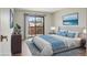 Nicely decorated bedroom boasts a large bed, modern decor, and sliding door access to a private balcony at 540 S Forest St # 3-204, Denver, CO 80246